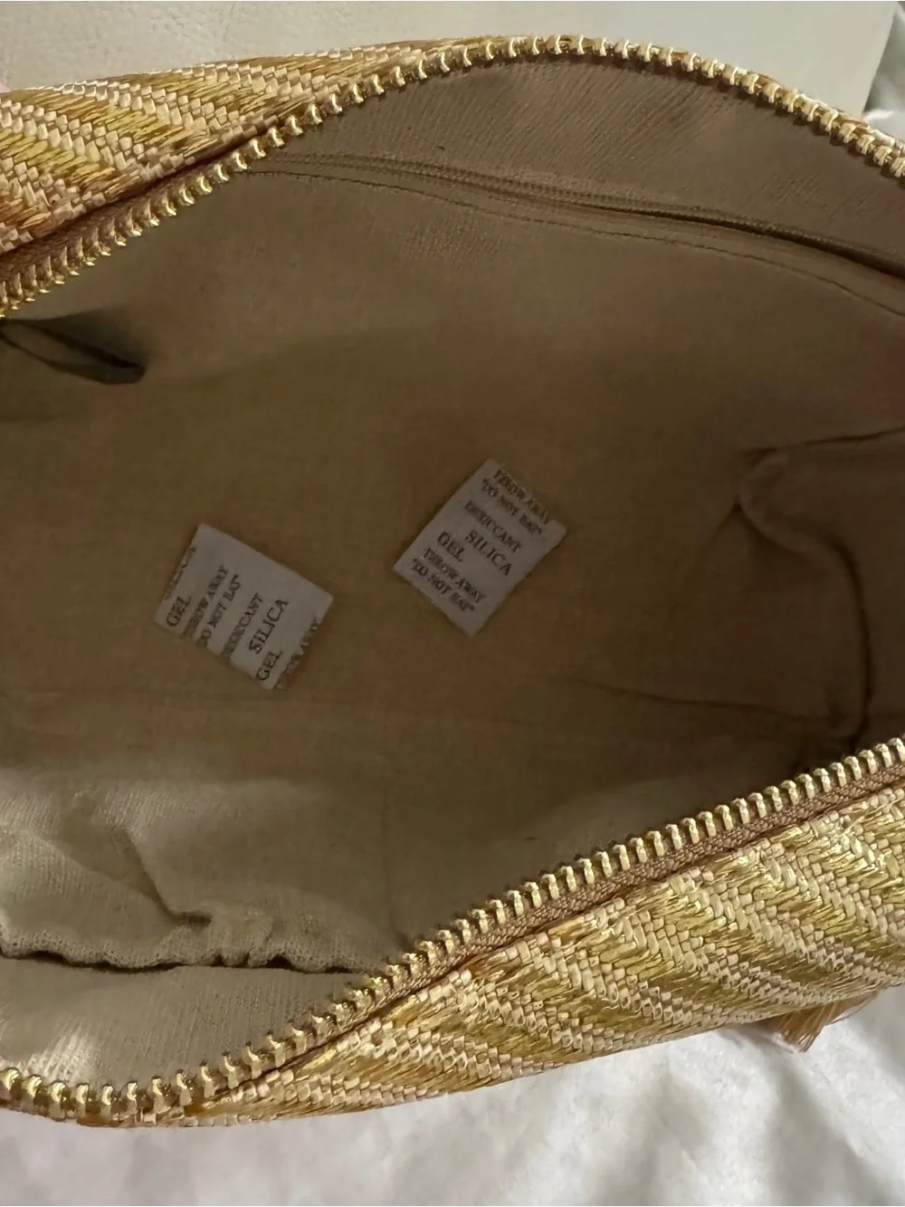 Vince Camuto gold woven canvas metallic cosmetic Bag with starfish Tassel charm.